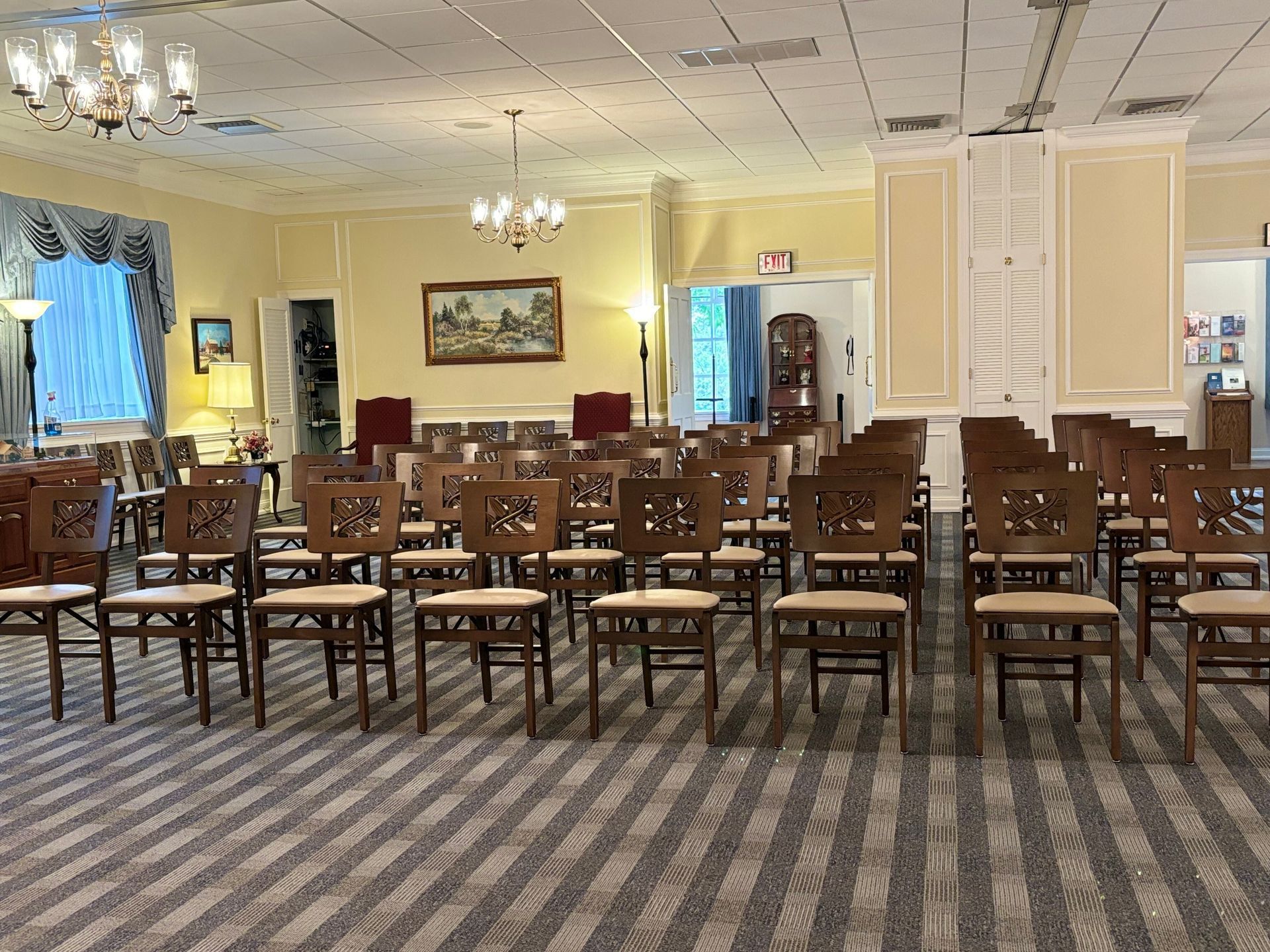 A room with rows of chairs and a couch