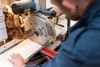 handyman working with table saw