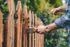 handyman painting fence