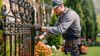 handyman fixing wrought iron fence