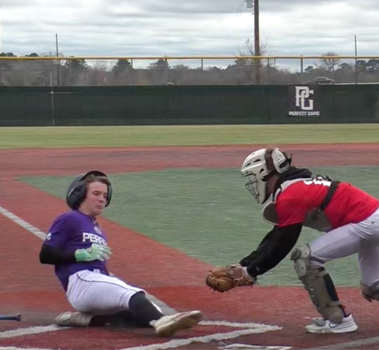 Image of a game highlight from a Perfect Game showcase. The runner is sliding into home where the catcher is trying to make the tag.