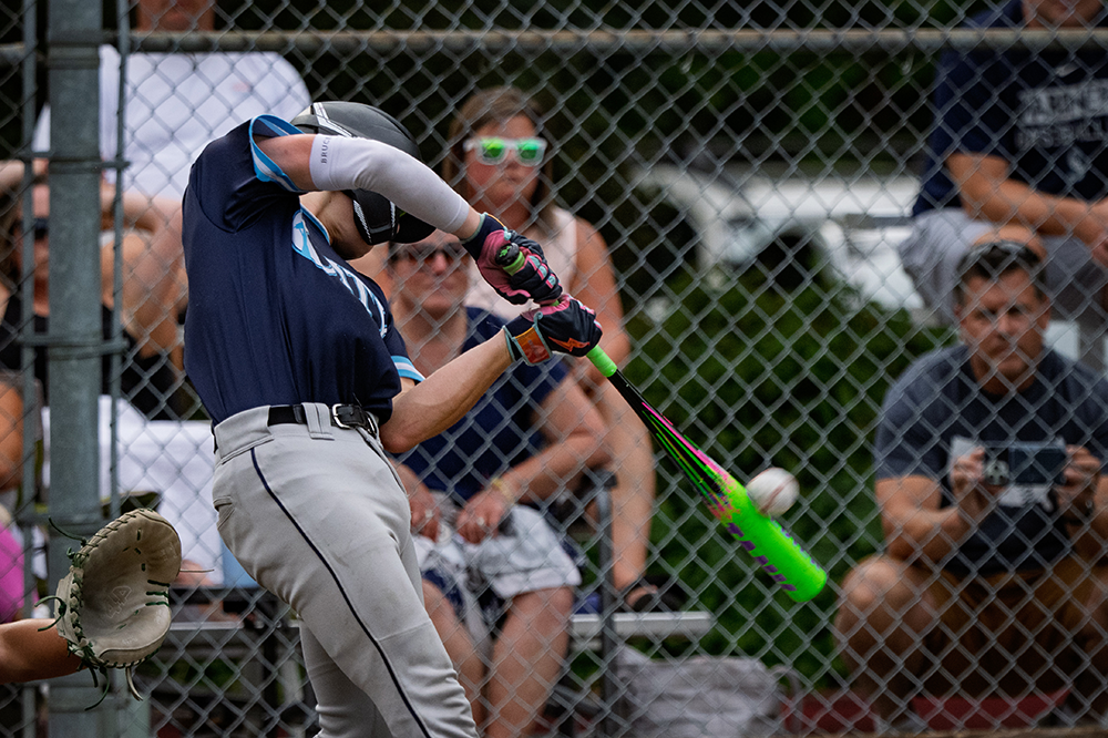 Tom Koerick Jr. filming his son hitting a baseball at a baseball game