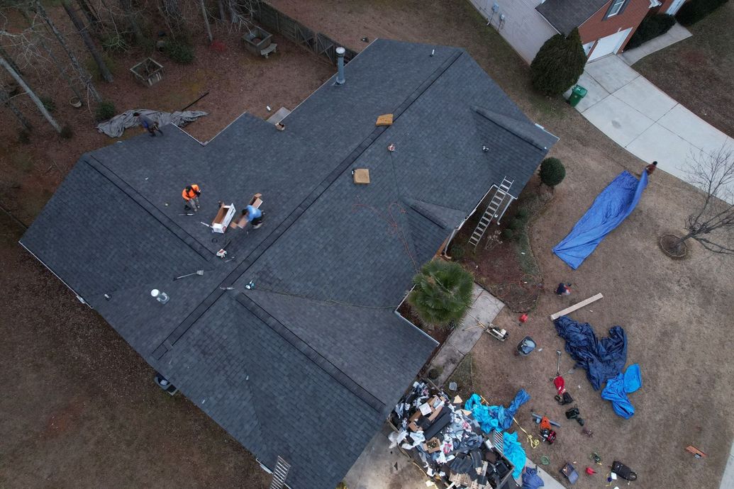 An aerial view of a house with a roof being installed.