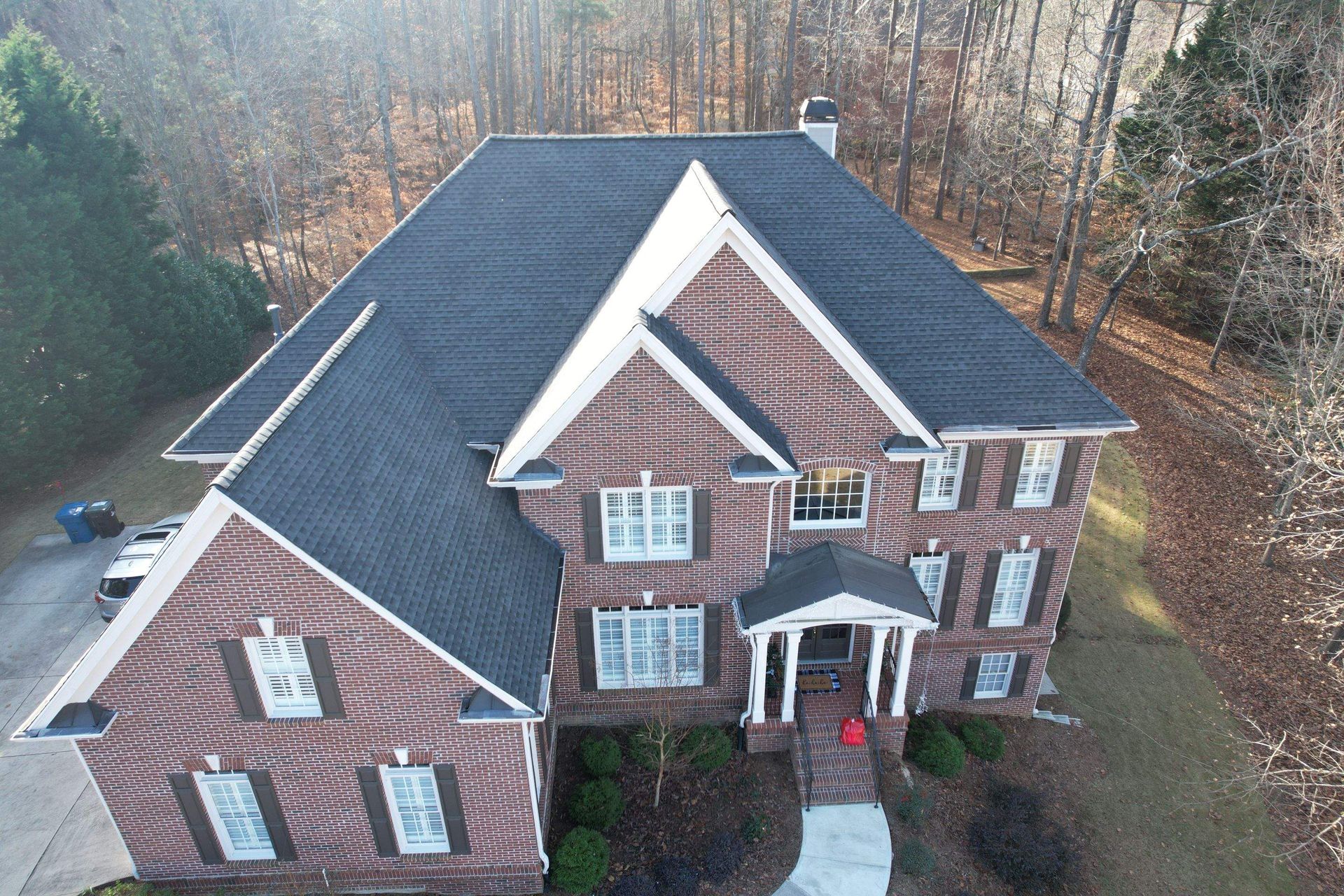 An aerial view of a building with a white roof.