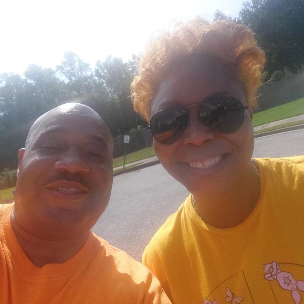 A man and a woman are posing for a picture together.