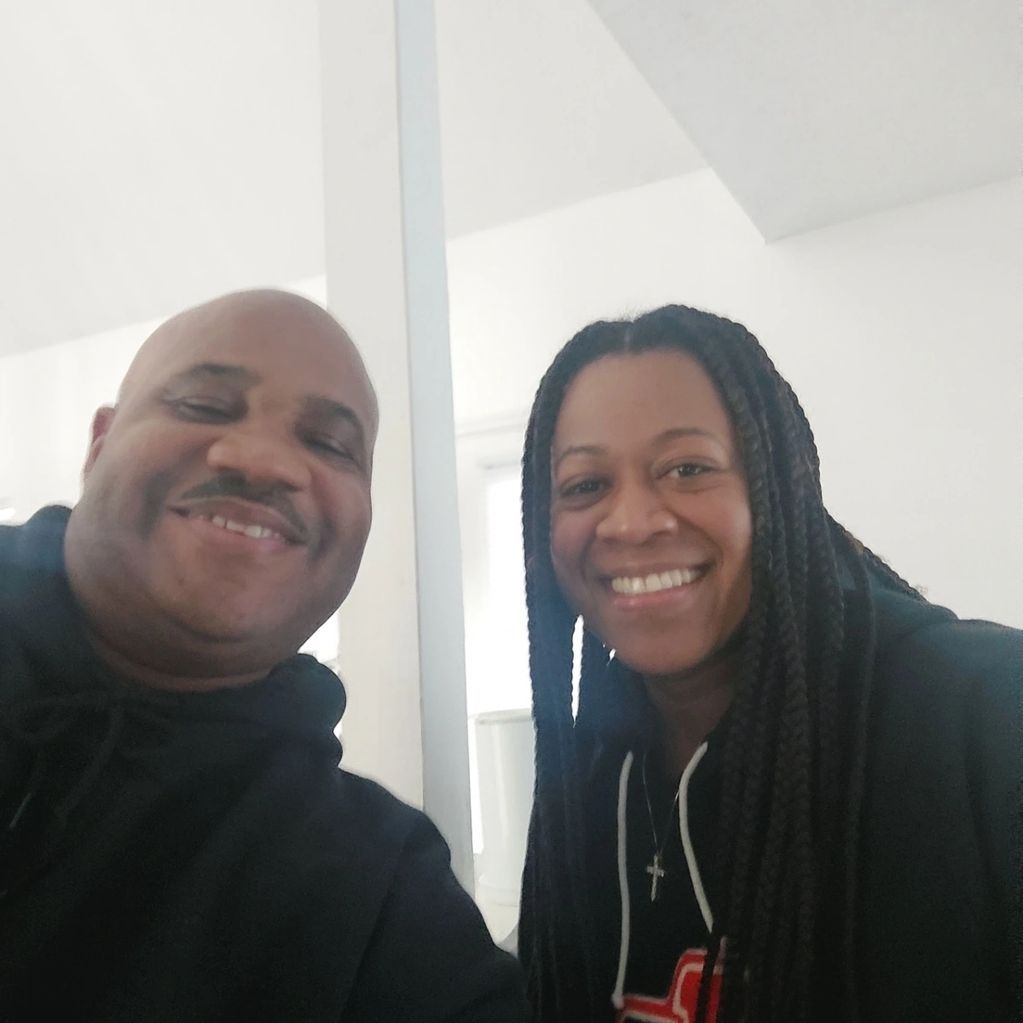 A man and a woman are posing for a picture and smiling