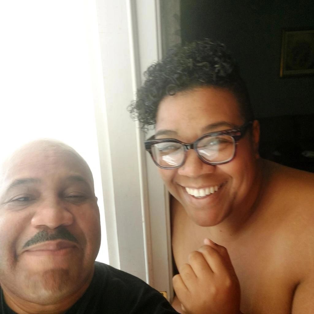 A man and a woman are posing for a picture and smiling