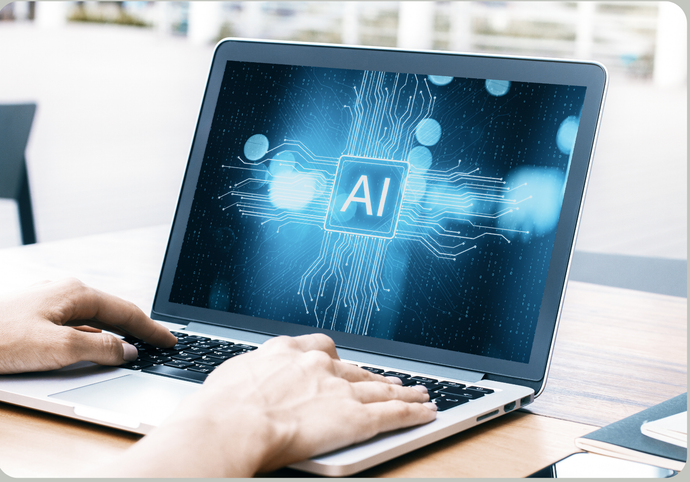 Person typing on laptop with AI graphic on the screen. Blue and white display with AI text and circuit-like lines.