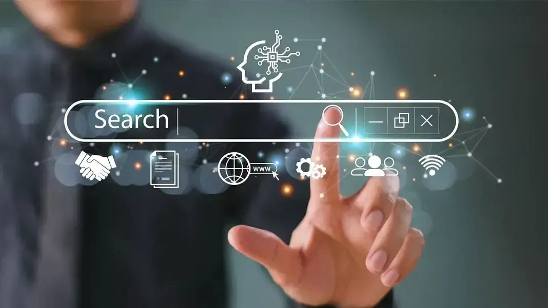 Person's finger pointing toward a glowing search bar overlaid on a blurred business setting, symbolizing internet search and technology.