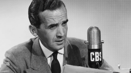 Man speaking at a CBS microphone in a black-and-white photo