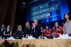 White House Correspondents’ Association event with seated attendees and red-uniformed performers on stage