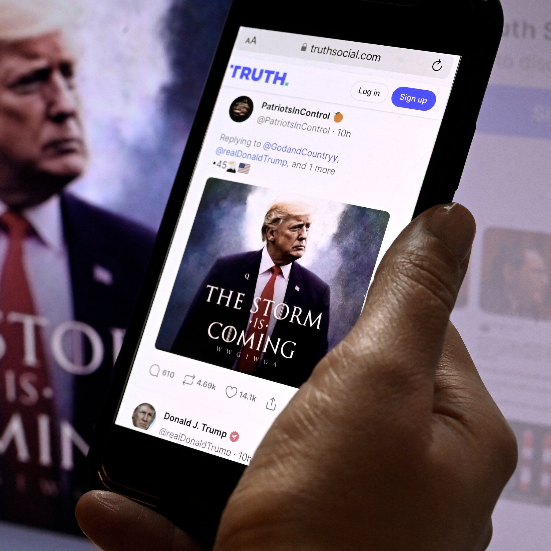 Person holding phone displays Donald Trump's "Truth Social" post, book cover "The Storm is Coming."