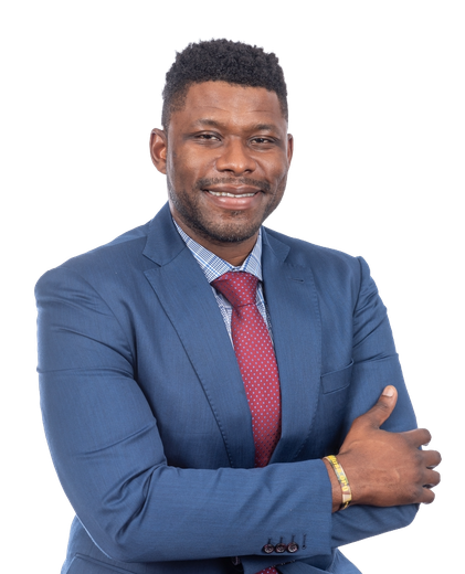 Man in blue suit, red tie, and patterned shirt, smiling with arms crossed.