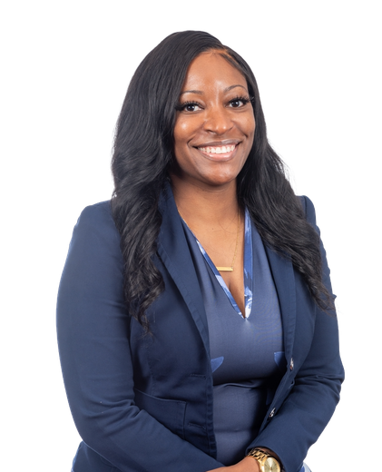 Woman smiling, wearing a dark blue blazer over a patterned top.