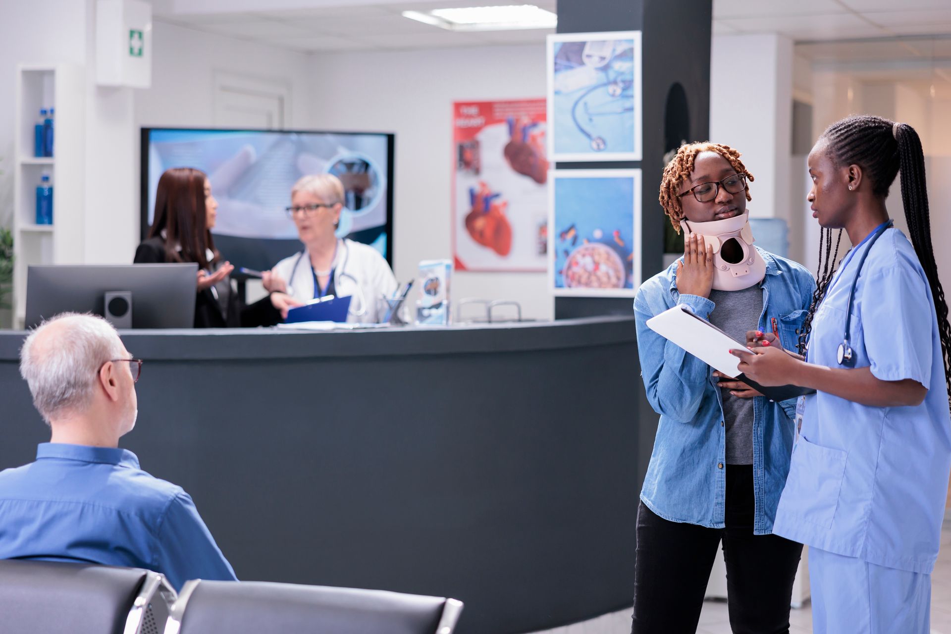Patient with neck brace talking to a nurse in a medical office