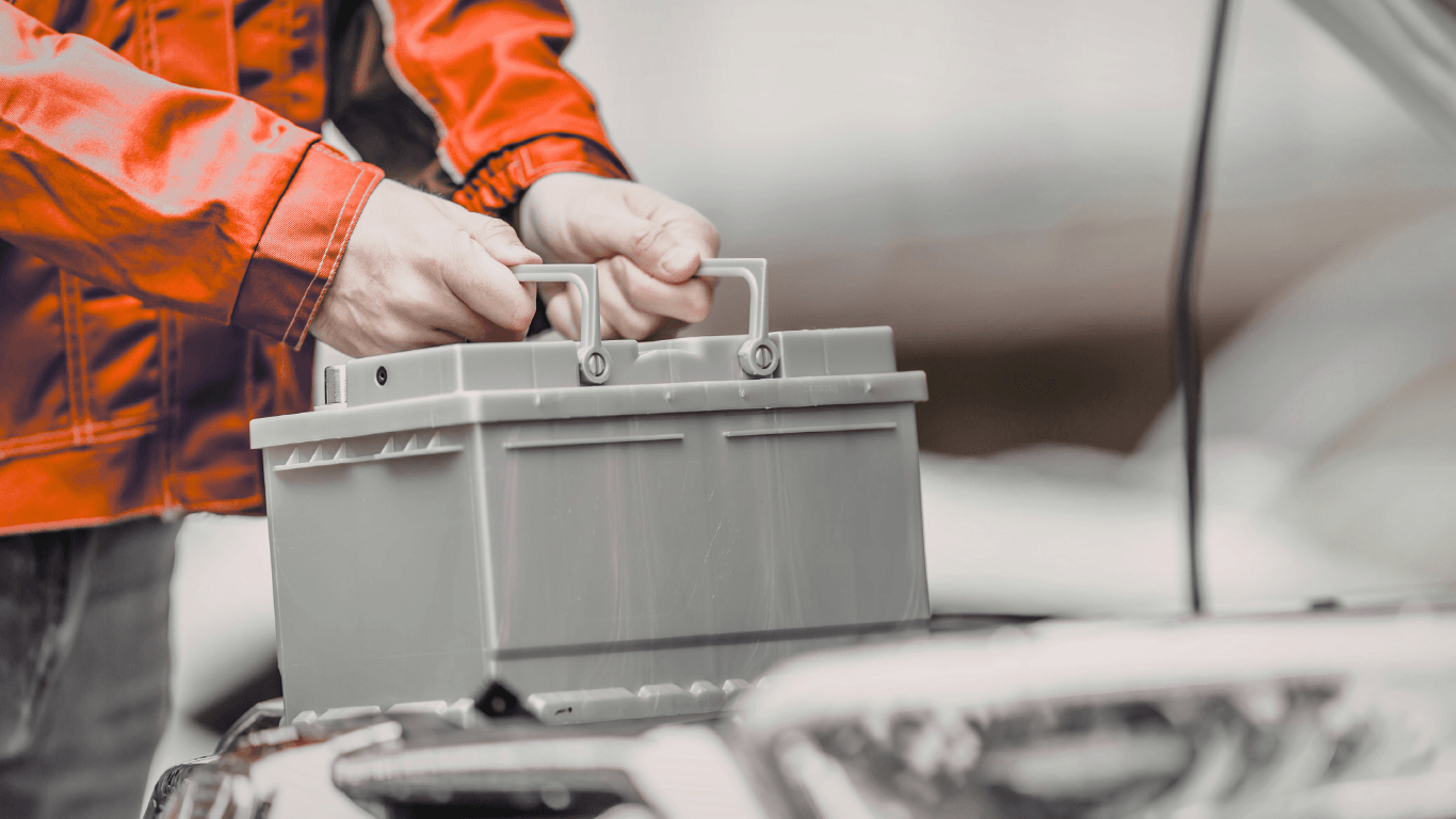 a mechanic replacing a battery in Conroe Tx