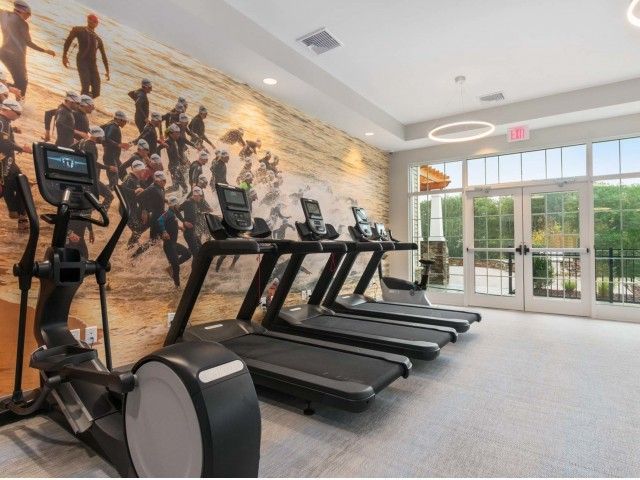 Gradient apartment community fitness center with oversized windoes.