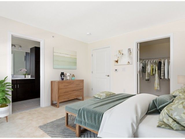 Gradient apartment bedroom with an in-unit bathroom and a walk-in closet.