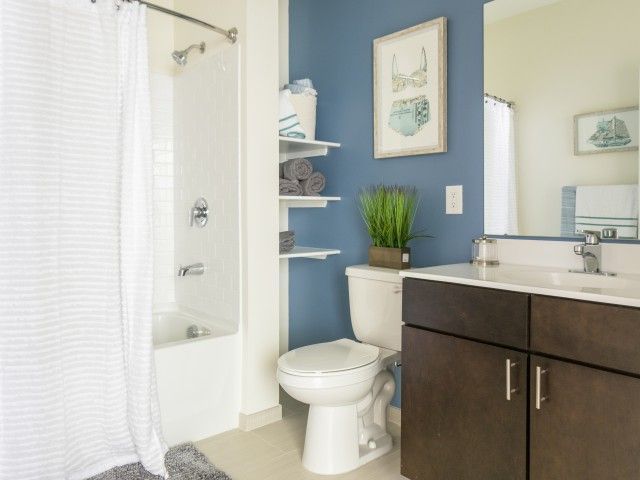 Gradient apartment bathroom with shower/bath.