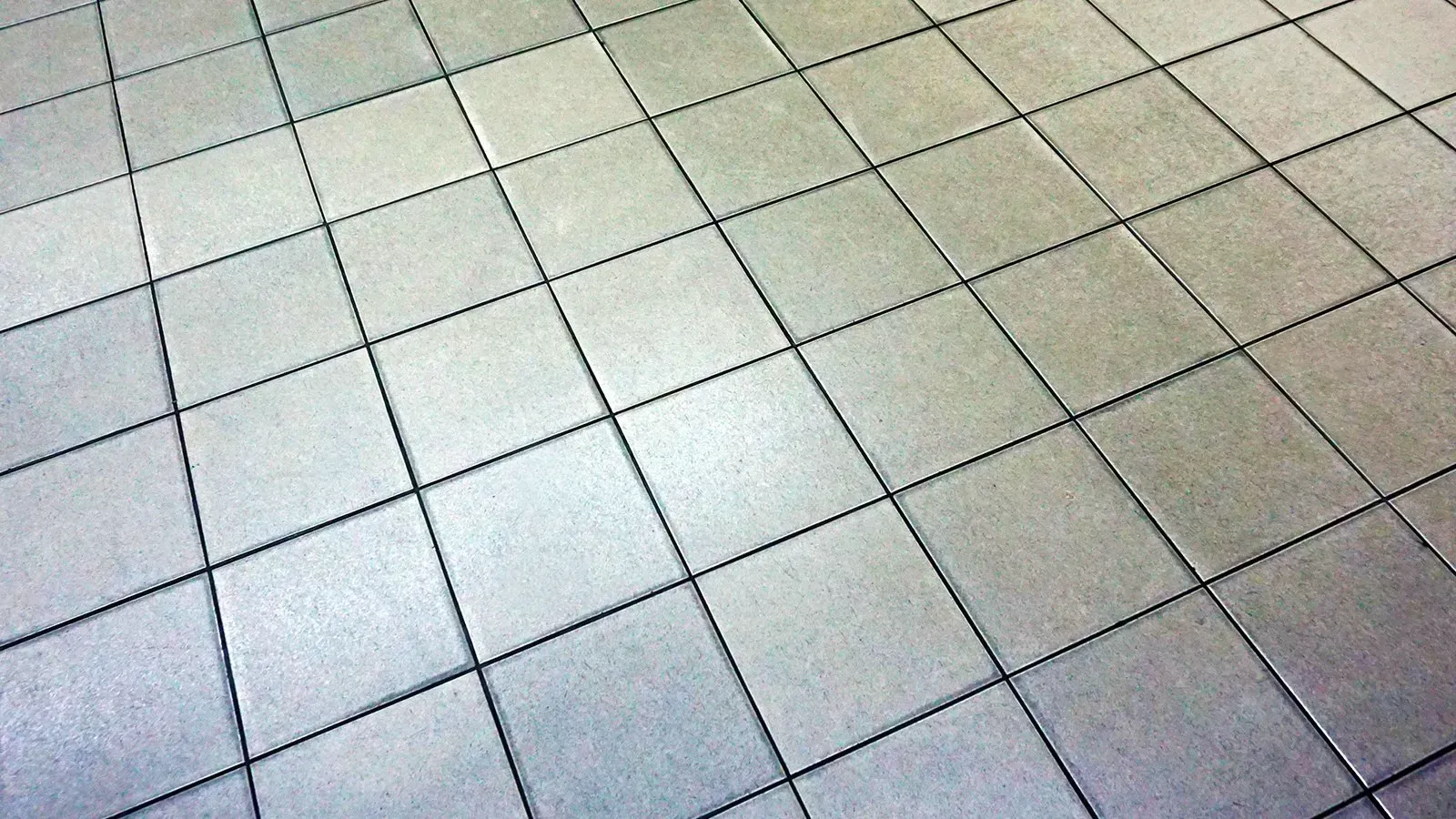 A close up of a tiled floor with a checkered pattern