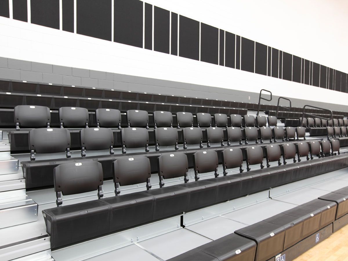 Ferris State University telescopic bleachers featuring EXCEL Seat Modules with ComfoBack Backrests, both in black.