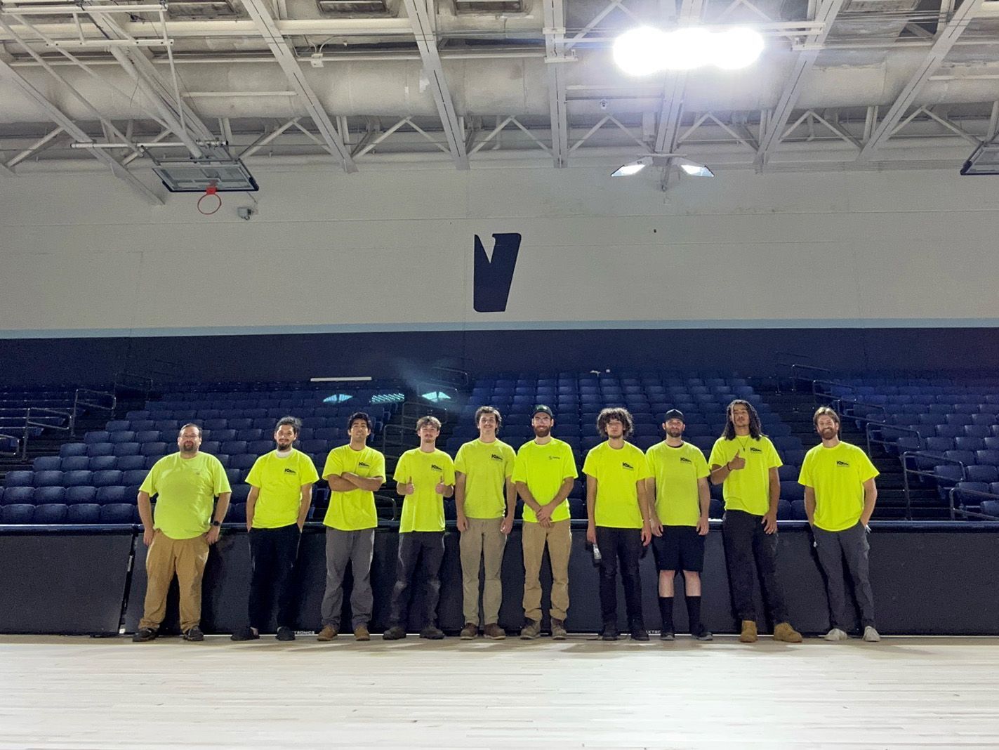 The full installation team of Kalamazoo Seating Service Group KSSG, in front of a completed section of bleachers.