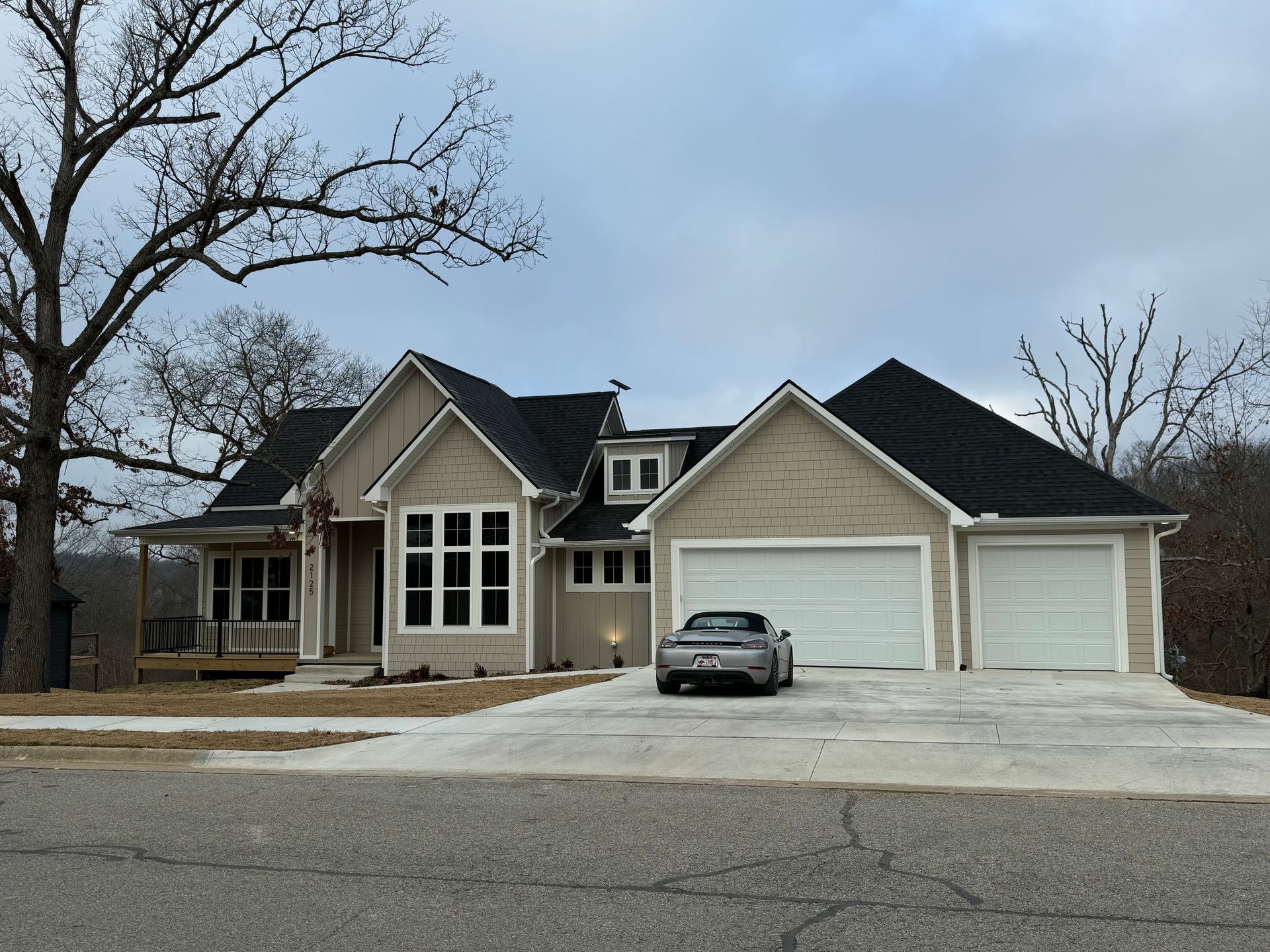 A large house with a garage and a driveway in front of it.