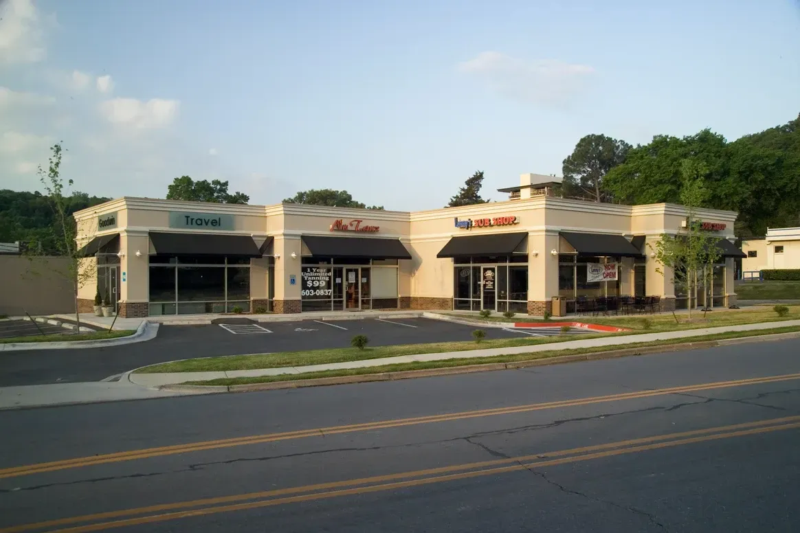 A building with a lot of windows and awnings on it