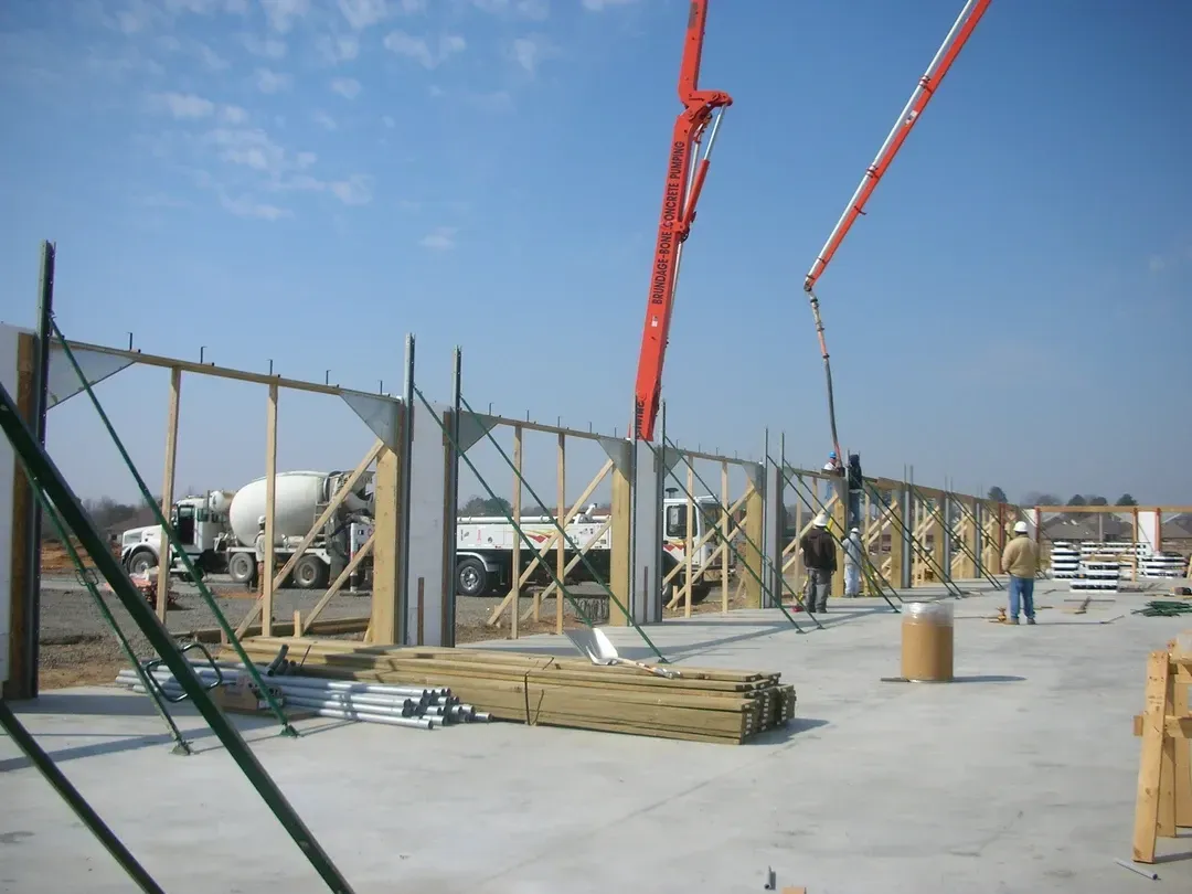 A construction site with a concrete mixer in the background