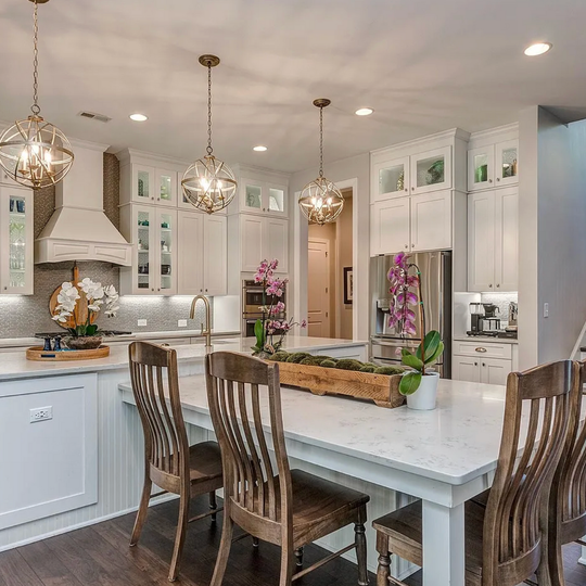 A kitchen with a table and chairs in it