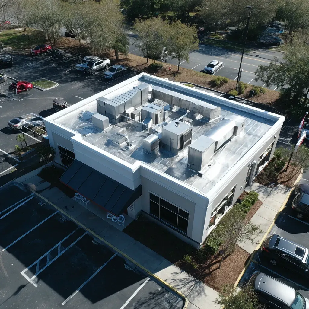 Complete commercial flat roof installation Riverview FL with insulation board, termination bars, and water drainage improvements.