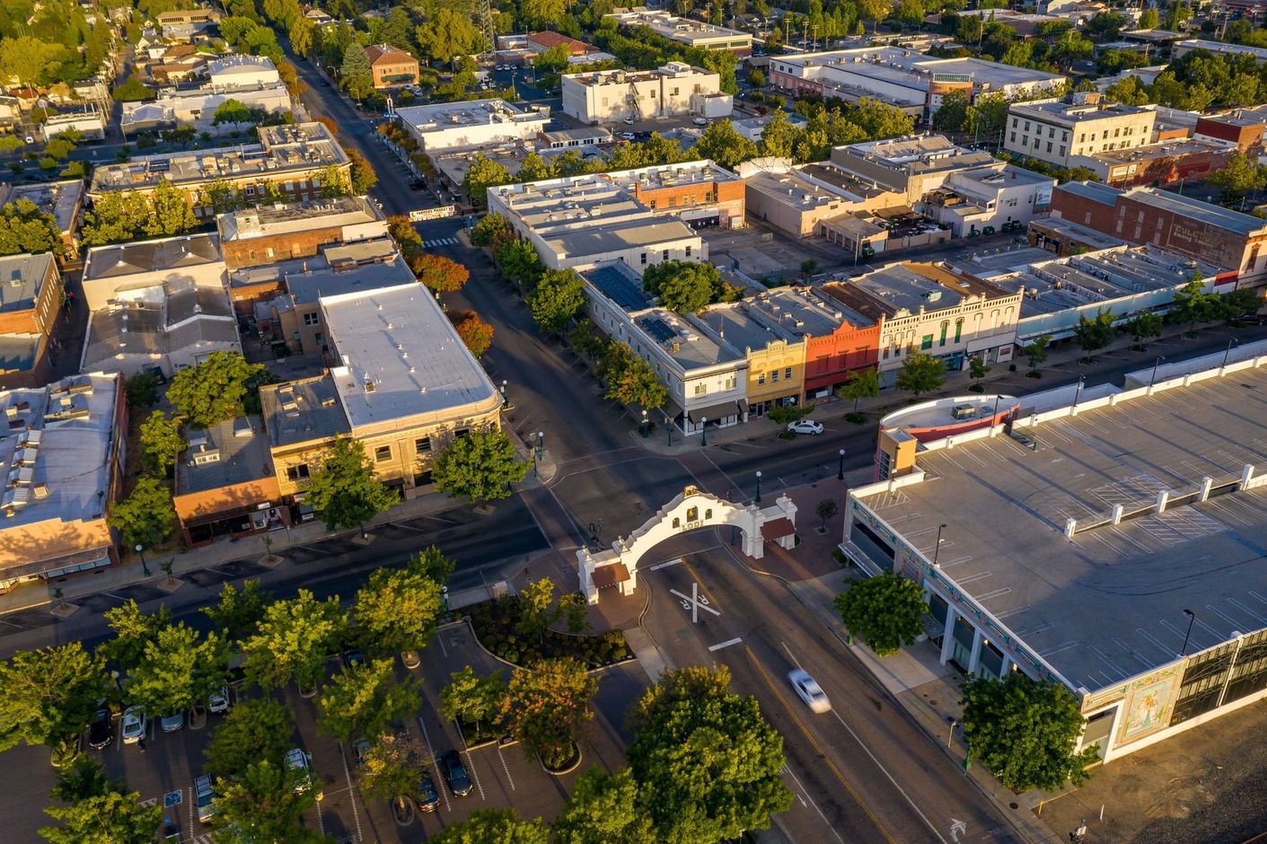 An aerial view of a city with lots of buildings and trees.