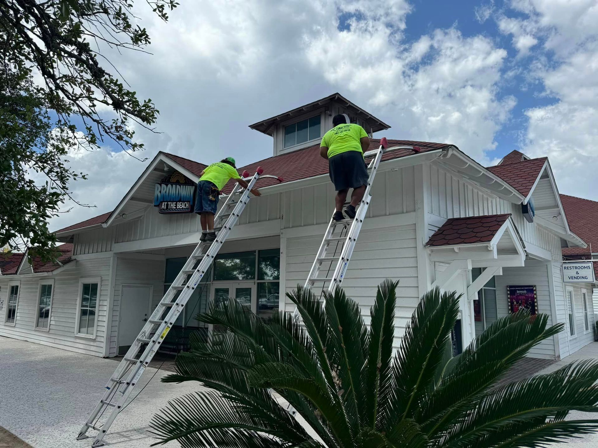 A car is parked in a garage next to a house with gutter in Coastal Carolina.