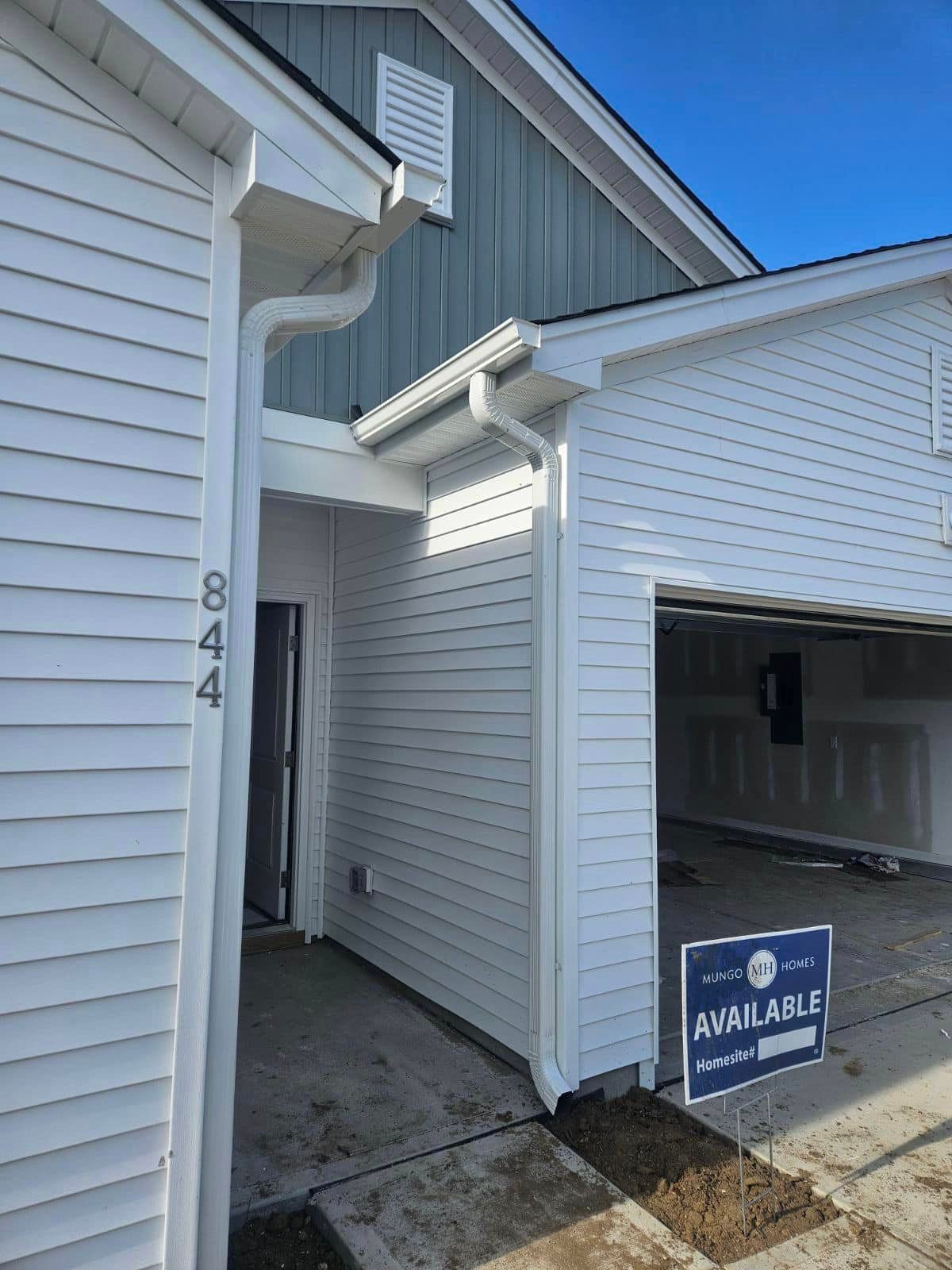 A white house with a newly installed gutter in Johnsonville