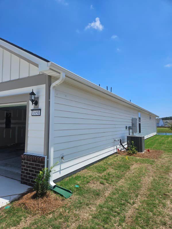 The side of a house with a garage and gutter in Johnsonville
