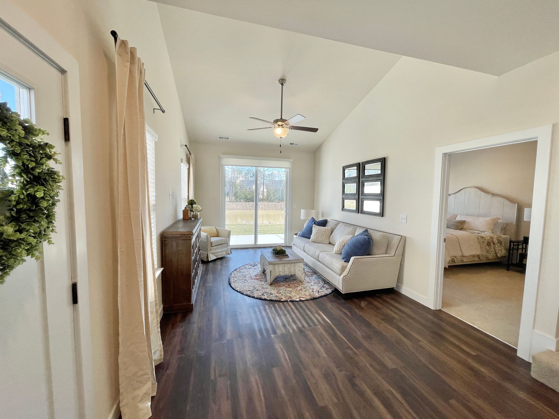A living room with a couch and a ceiling fan.