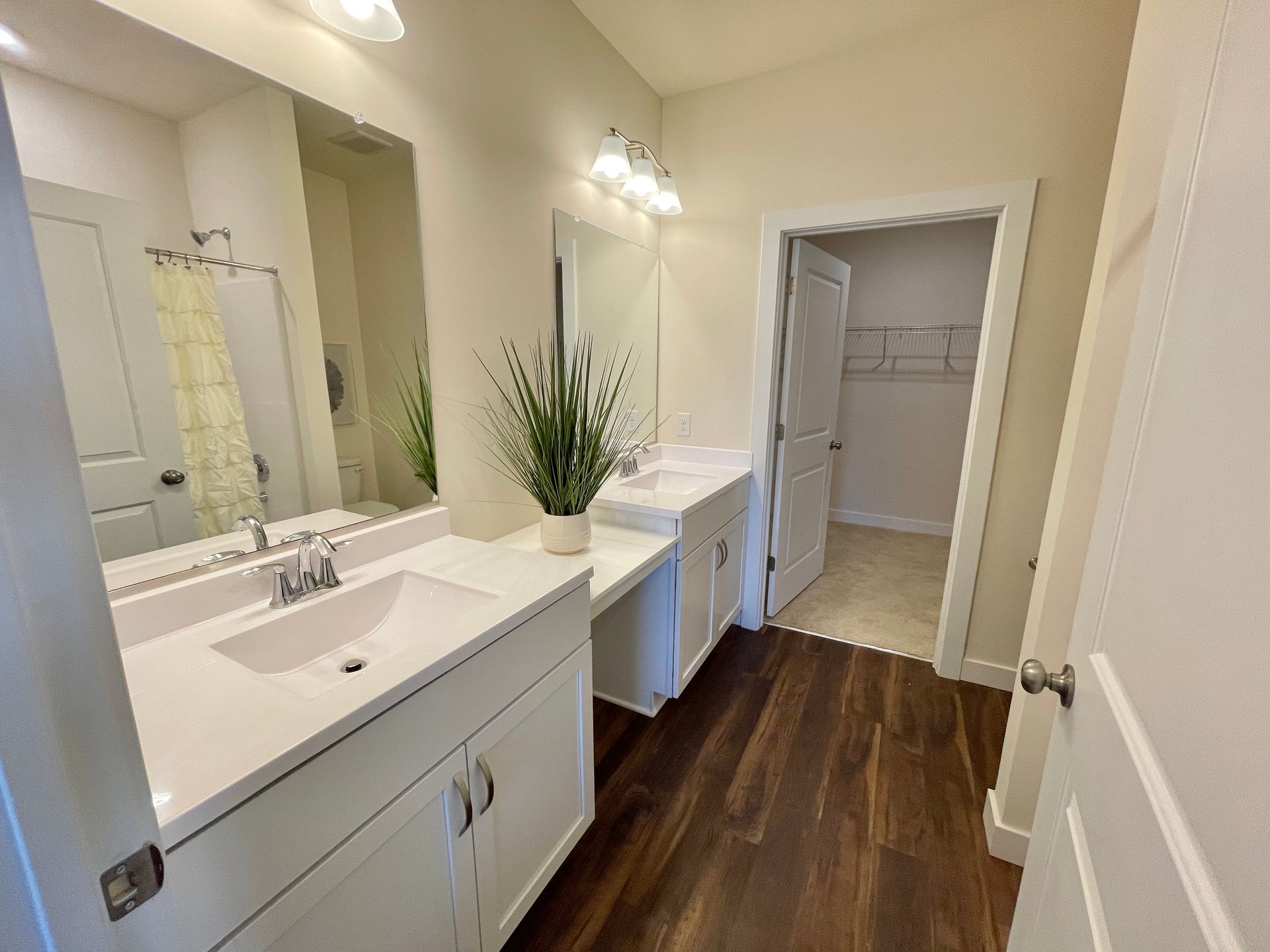 A bathroom with two sinks and a large mirror.