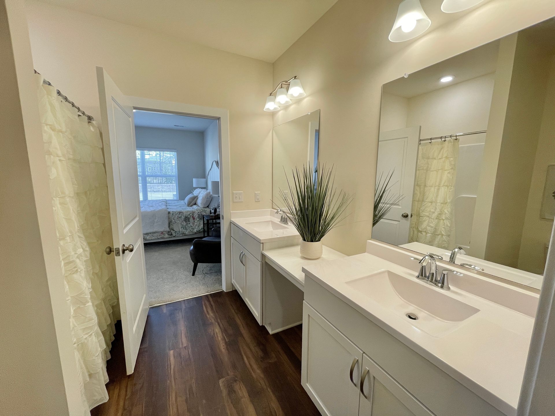 A bathroom with two sinks and a large mirror.