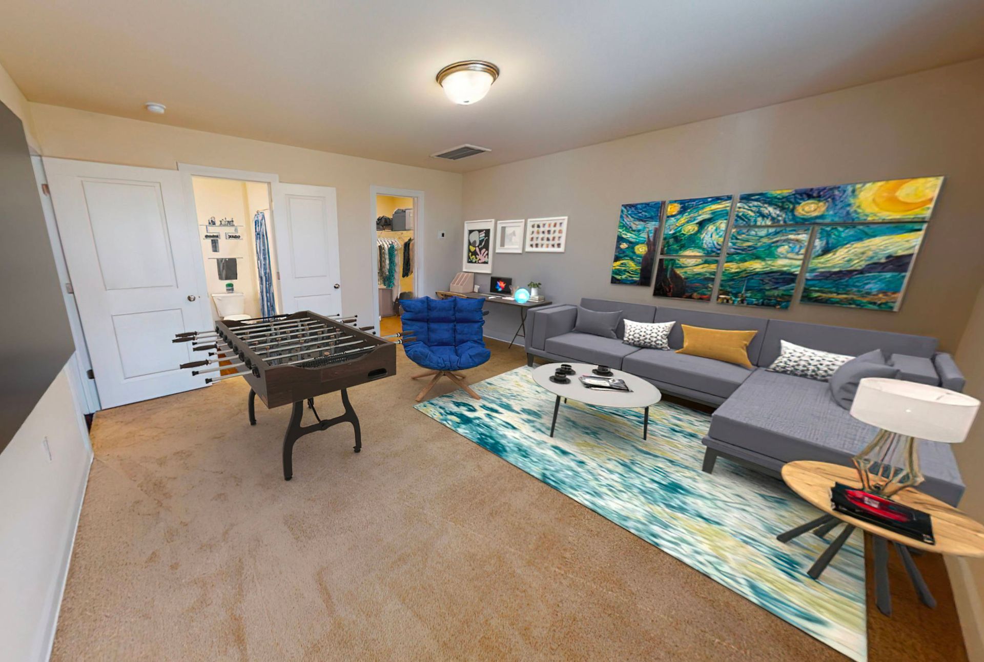 A living room with a couch , table and chairs