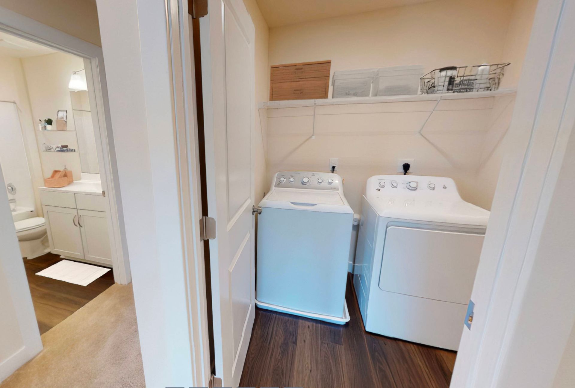 A laundry room with a washer and dryer in a house.