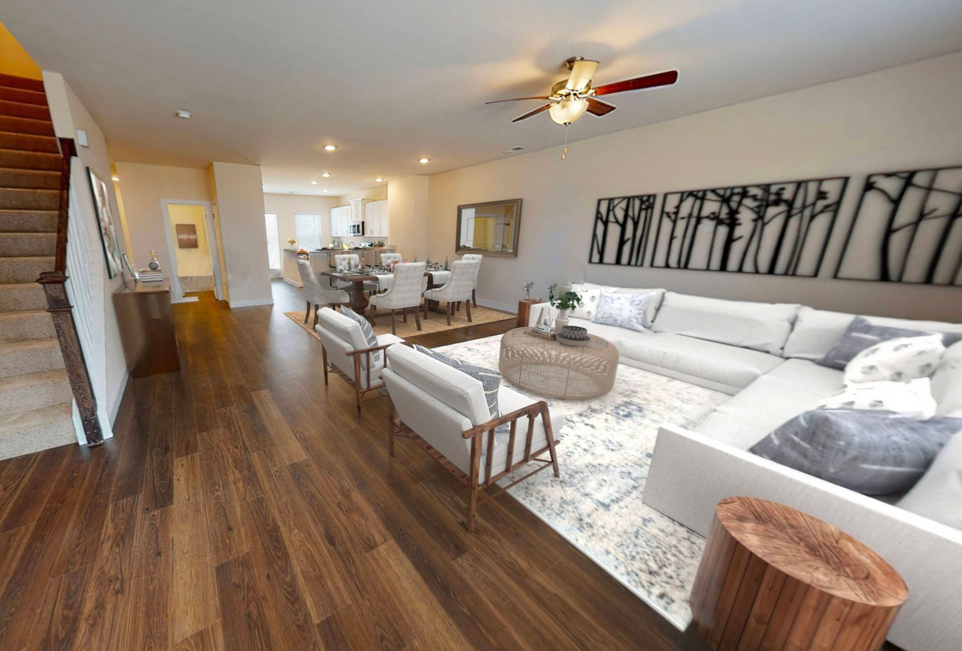 A living room filled with furniture and a ceiling fan.