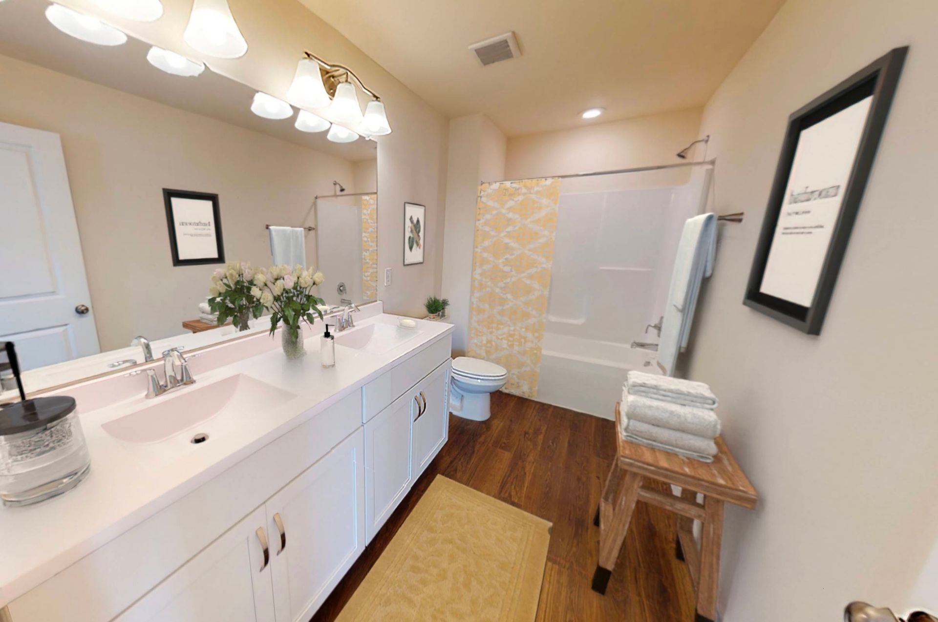 A bathroom with a sink , toilet , tub and mirror.