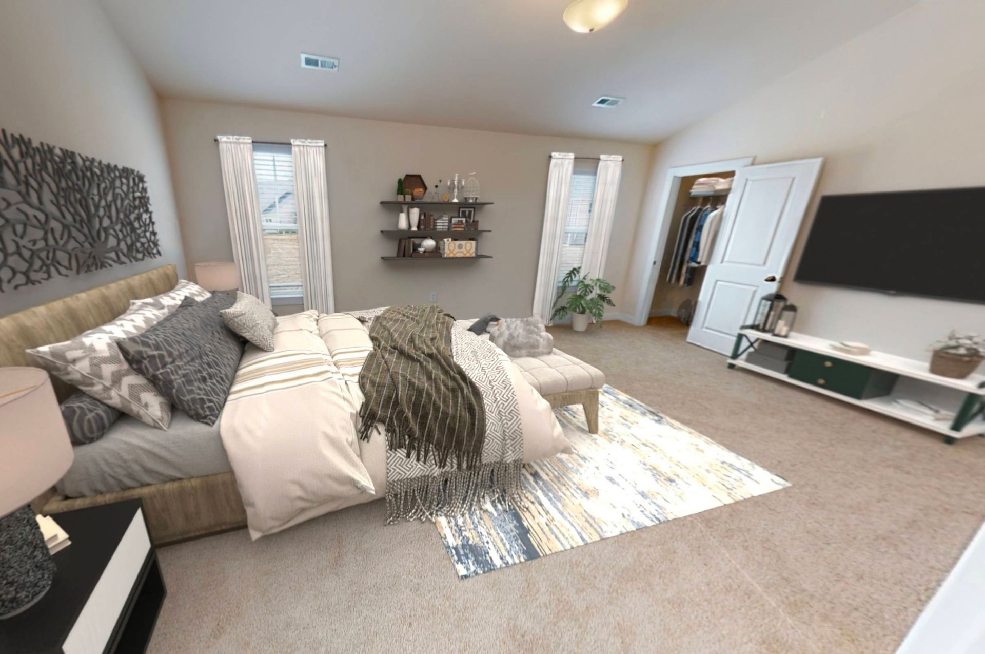 A bedroom with a large bed and a flat screen tv.