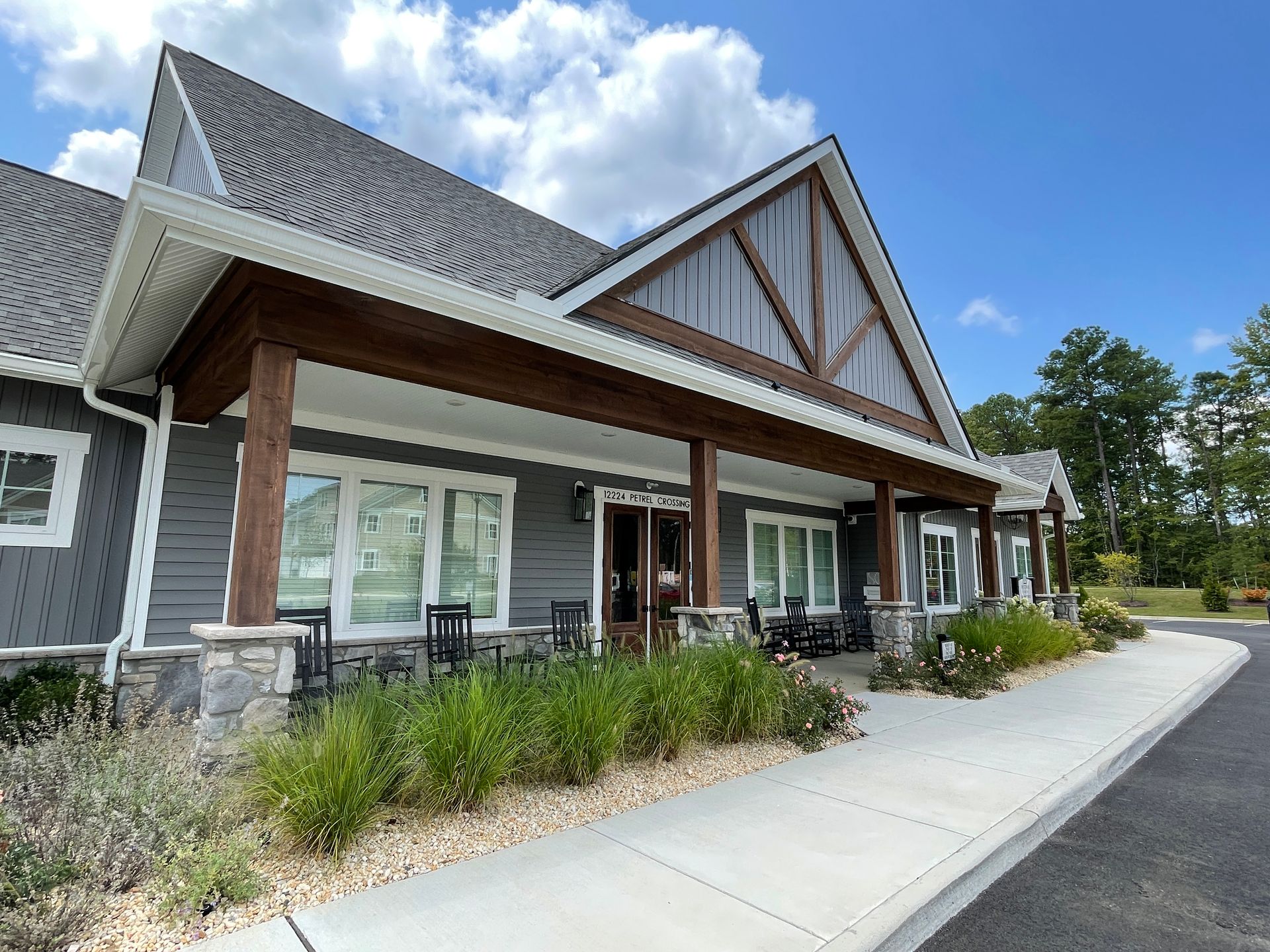 A large house with a large porch and a lot of windows