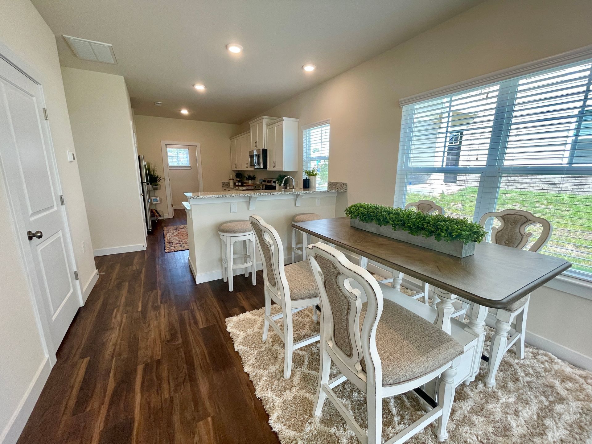 A dining room with a table and chairs in a house.