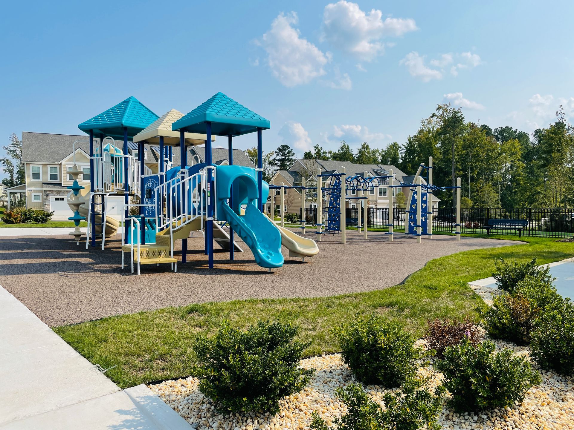 A playground with a slide and a swing set in a park.