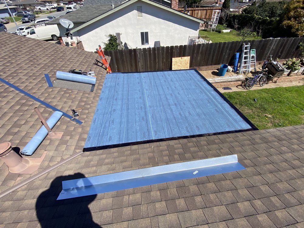 A roof with a blue tarp on top of it