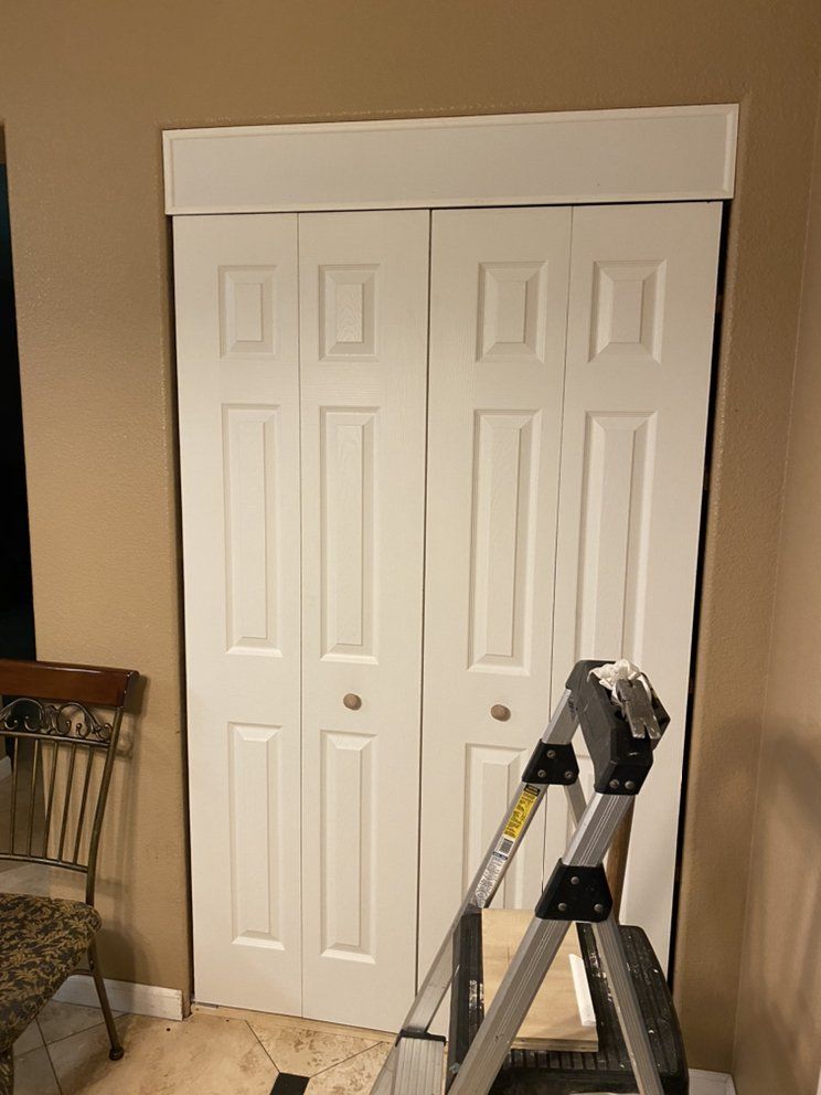 A ladder is sitting in front of a closet door.