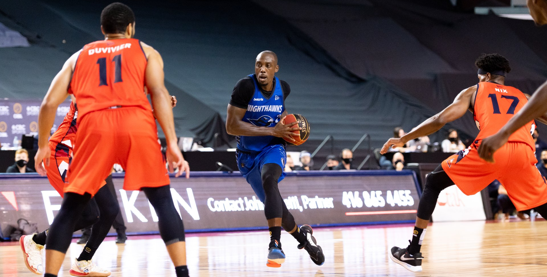 Canadian National Team Veteran, Olu Famutimi drives to the basket with three defenders from the Fraser Valley Bandits garding him. The athletes are professional playing in Canada's only professional league, The Canadian Elite Basketball League (CEBL)