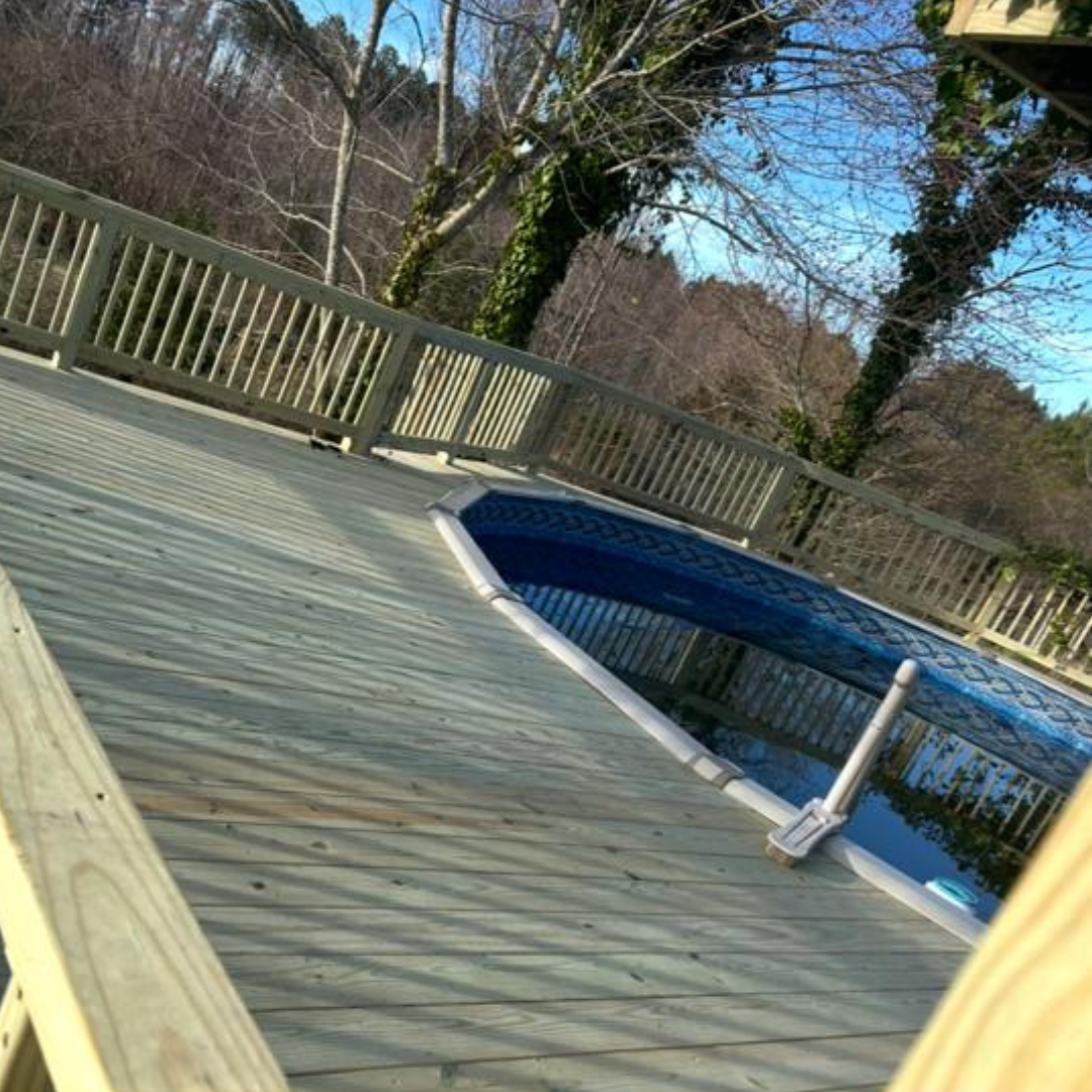 Bright white kitchen with island, cabinets, stainless steel appliances, and hardwood floors.